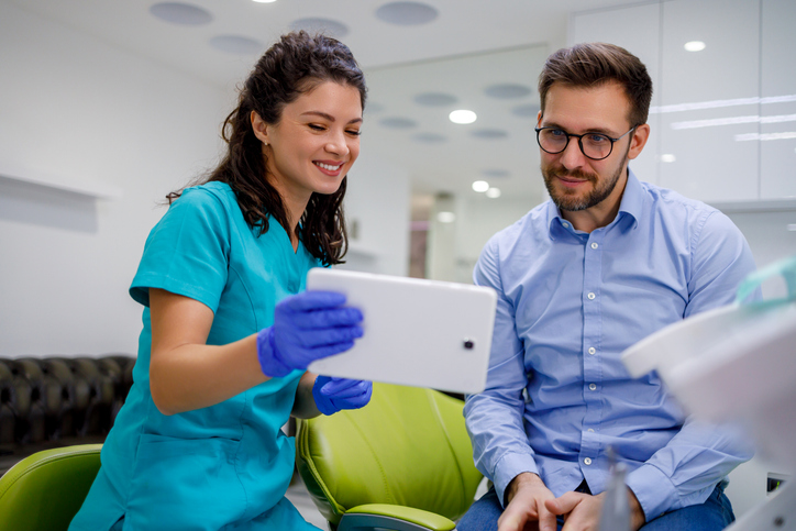 male dental patient consultation with female dentist