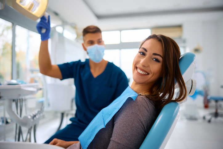 happy female dental patient in dental chair