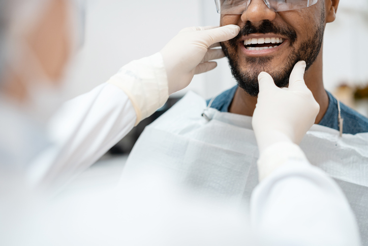 dentist examining a young man's teeth